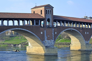 Italy - Pavia - The Covered Bridge (also called Ponte Vecchio) on the ticino with the Cathedral of...