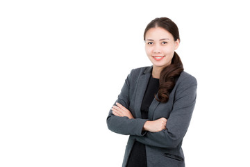 Portrait of a Attractive young Asian confident businesswoman wearing a suit with happy face and crossed arms isolated on white background.