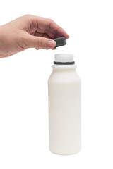 Hand opening the cap of full milk in plastic bottle isolated on white background with clipping path