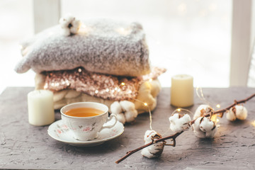 tea Cup, top with sequins, candle, cotton on grey background