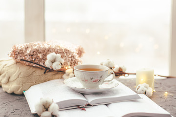 tea Cup, top with sequins, candle, cotton on grey background