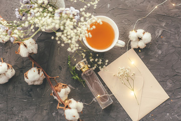 tea Cup, top with sequins, candle, cotton on grey background