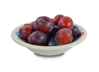 Plums in a plate- fresh fruit from the garden isolated on white background