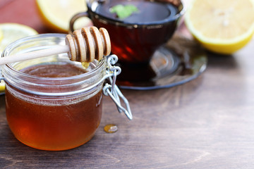 Fresh honey with a cup of black tea