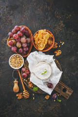 Cheese with honey, nuts and grapes