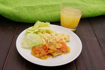 Tofu and vegetables with millet on a table