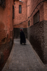 Fototapeta na wymiar Old men walking in narow street in Morocco