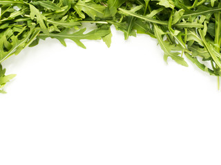 Frame of green arugula leaves on white background Copy space