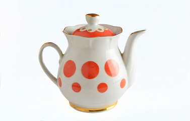 Ceramic white teapots in red polka dots on a white background..