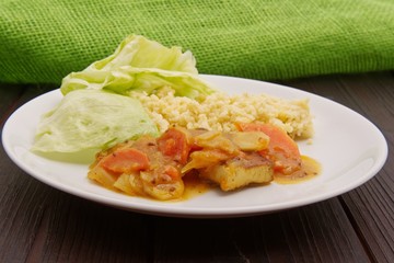 Tofu and vegetables with millet on a table
