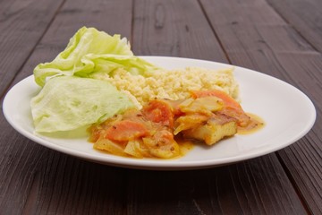 Tofu and vegetables with millet on a table