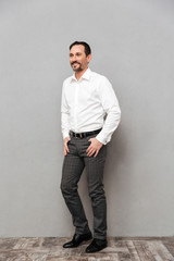 Full length portrait of a happy mature man dressed in shirt