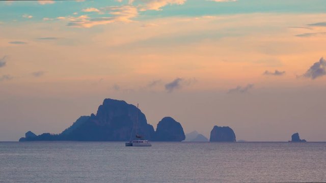 Koh Poda and Chicken islands with a yacht catamaran on average plan at sunset. Krabi province in Thailand.