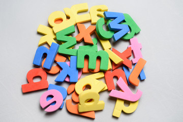 Naklejka premium Colorful letters toys on a white background.