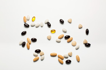 Pills, vitamins, fish oil on white background
