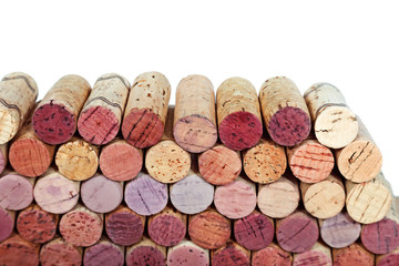 Wall of wine corks isolated on white background. Multicolored corks from white and red wine bottles.