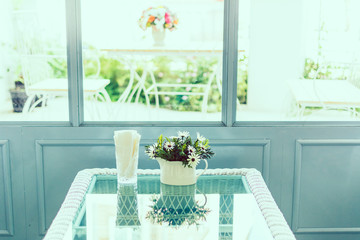 A small flower plant pot displayed at a cafe.