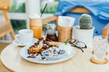 Toasted waffles with vanilla ice cream in a plate
