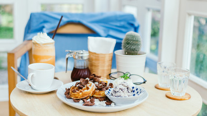 Toasted waffles with vanilla ice cream in a plate