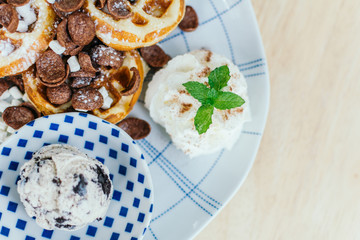 Cocoa crunch waffle with ice cream in cafe.