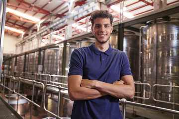 Portrait of a young Hispanic man working at a wine factory