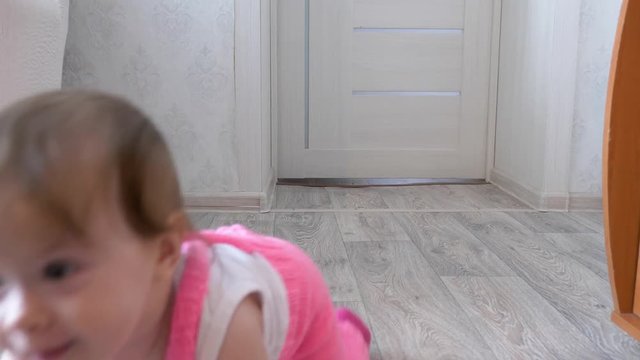 cheerful little child crawls on floor