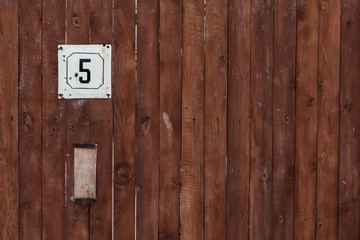 number of street address with a wooden wall