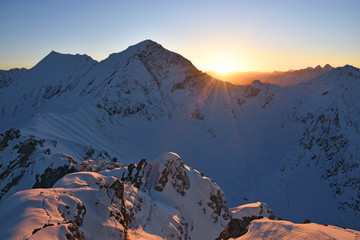 Colorful Sunset at the summit of Tauberspitze (Lechtal Alps) in winter. Tirol, Austria - obrazy, fototapety, plakaty
