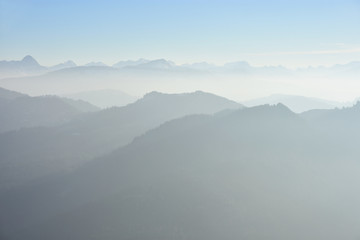 Hazy silhouette of mountains in the European Alps. Allgaeu Alps and Lechquellengebirge, Germany, Austria.