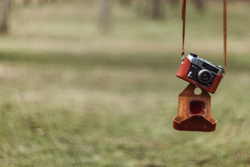 Vintage film camera on blurred nature background