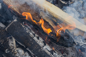 burning wood billets, flames and smoke