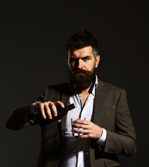 Businessman with serious face in suit on black background