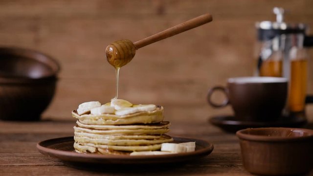 Cinemagraph - Breakfast, pouring honey on pancakes. Nobody. Living Photo.
