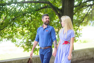 Romantic couple concept. Bearded man walks with his girlfriend.