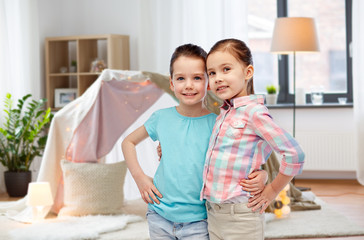 happy smiling little girls hugging at home