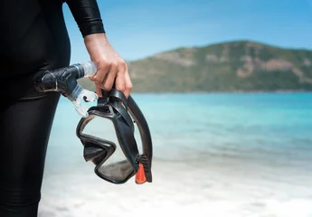 Foto op Aluminium Diving goggles and snorkel gear in hand near beach © Aunging
