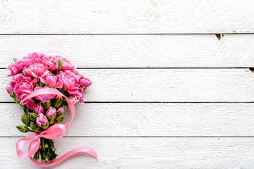 Fresh flowers bouquet, overhead on white wooden background, wedding romantic decoration