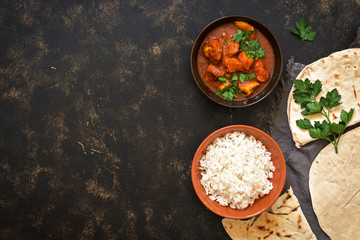 Indian dish Chicken Tikka masala with rice. Top view, copy space.