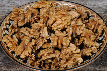 Walnuts in a plate. Front view.