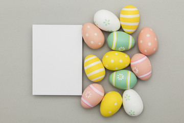 Easter holiday background. Pastel coloured decorated easter eggs with a blank white label.