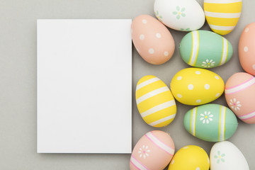 Easter holiday background. Pastel coloured decorated easter eggs with a blank white label.