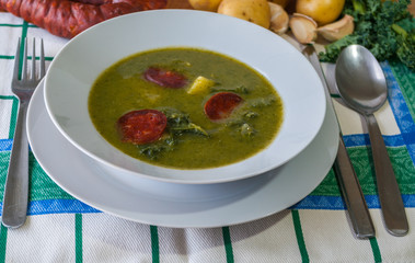 Caldo Verde - traditional Portuguese green soup made with kale, potatoes, onion, garlic and chorizo served for Festa de São João in June