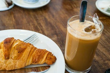Cafe culture: iced coffee and a croissant 