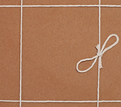 A brown parcel wrapped with string.