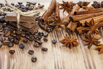 Obraz na płótnie Canvas Chocolate, Coffee Beans, Spices, Cinnamon on the Wooden Table.