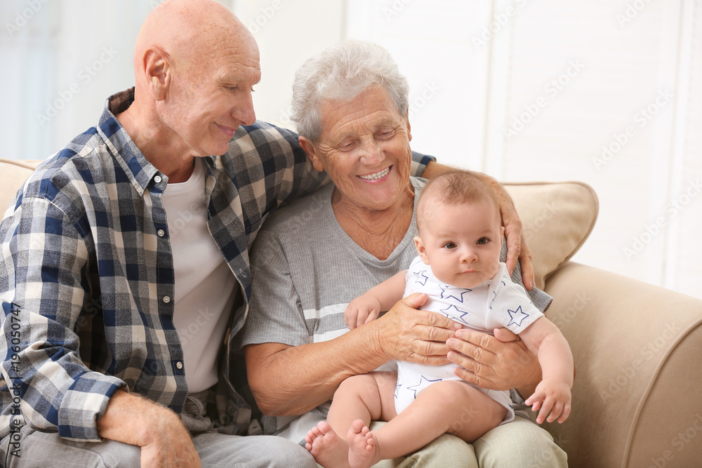 Poster Senior couple with their little grandchild resting at home