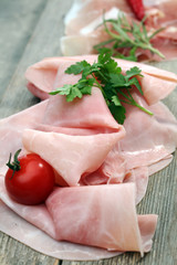 Sliced ham on wooden background. Fresh prosciutto. Pork ham sliced