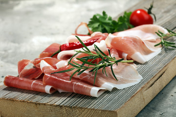 Italian prosciutto crudo or jamon with rosemary. Raw ham