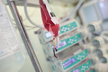 Package with donor blood hanging on a tripod for transfusion
