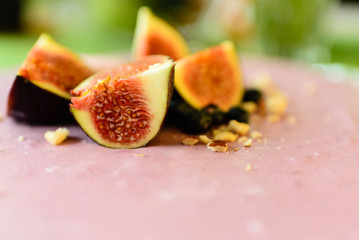 Raw vegan dessert. Blueberry cheesecake with figs and hazelnuts. Close up. 